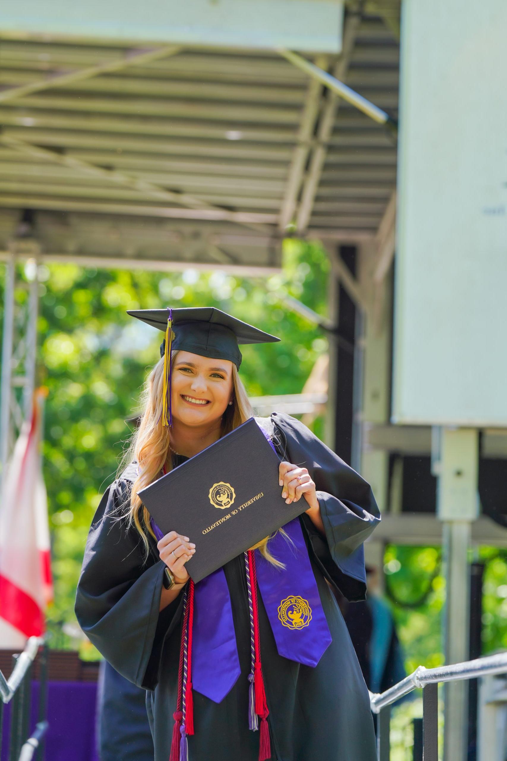 A UM student celebrates at Commencement.